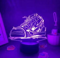 an illuminated sneaker is sitting on top of a table next to some magnets