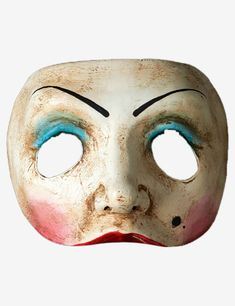 an old mask with blue eyes and red nose