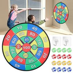 two children are playing with a colorful wheel of fortune