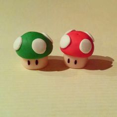 two small toy mushrooms sitting next to each other