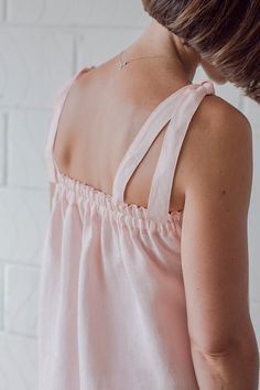 the back of a woman's pink top