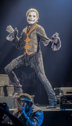 a man dressed as the joker performing on stage