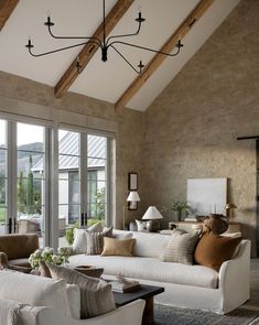 a living room filled with furniture and lots of windows