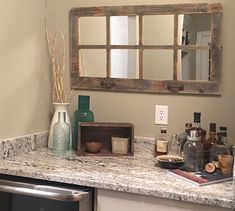 a kitchen counter with an oven and mirror above it