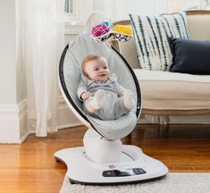 a baby is sitting in a swing chair