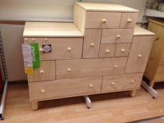 a wooden dresser sitting on top of a hard wood floor next to a cabinet with drawers