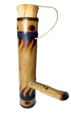 a small wooden tube with a handle that has been painted brown and black on it