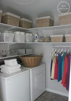 a washer and dryer in a laundry room with baskets on the shelves above