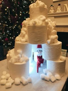 there is a large tower made out of toilet paper and marshmallows on the table