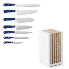 five knives with blue handles are next to a white box and wooden cutting board on a white background