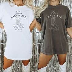 two women standing next to each other in front of a tin foil wall wearing t - shirts