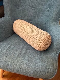 a pillow sitting on the back of a chair