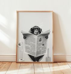 a dog is reading a newspaper while sitting on the floor in front of a white wall