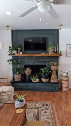 a living room filled with furniture and a flat screen tv mounted above a fire place