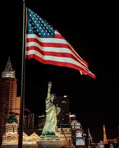 the statue of liberty is lit up at night