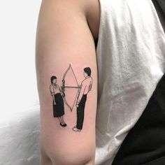 a woman with a bow and arrow tattoo on her left arm is standing next to a man