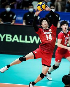 a man jumping up to hit a volley ball