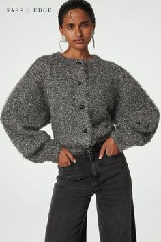 Crafted with a silver tinsel effect, crew neck and wide sleeves, this super cosy cardigan is finished with gathered shoulders, cute floral look buttons, wide ribbed cuffs, and a ribbed hem and collar. Glitter Cardigan, Old Grandma, Silver Cardigan, Round Neck Cardigan, Silver Fabric