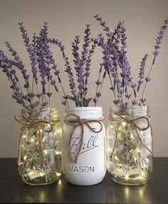 three mason jars with lavender flowers in them