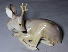 an antelope figurine sitting on top of another animal