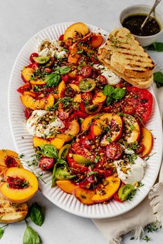 a white plate topped with grilled peaches and other food on top of a table