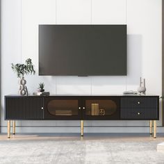 an entertainment center with a large flat screen tv mounted on it's sideboard