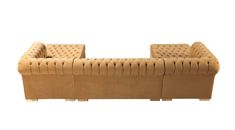 a large tan couch sitting on top of a white floor