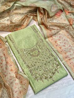 Its a beautiful unstitched suit material . Kurta - Chanderi soft premium digital printed fabric with beautiful zardozi handwork on neck .  Length - 2.5 mtr Dupatta - Soft orgenza digital printed dupatta  Length - 2.25 mtr  Bottom - shantoon , 2.25 mtr.  Please note - color may be a little different due to different light and photography . Suit stitching with cotton linning also available .  For any query please direct message us. Unstitched Suits Photography, Unstitched Multicolor Lawn Suit With Mirror Work, Wedding Salwar Kameez With Mirror Work In Cambric, Designer Cambric Lawn Suit With Mirror Work, Multicolor Lawn Suit With Mirror Work For Festivals, Festive Cambric Lawn Suit With Mirror Work, Elegant Handwork Lawn Suit For Wedding, Elegant Lawn Suit With Handwork For Wedding, Elegant Wedding Lawn Suit With Handwork