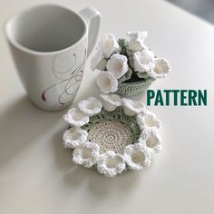 two crocheted dishes sitting next to each other on top of a white table