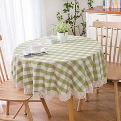 a dining room table with a green and white checkered tablecloth on the table