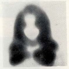 a black and white photo of a woman's face with her hands in the shape of a heart