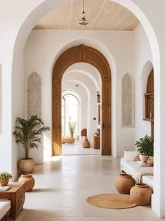 an archway leads to the living room and dining area in this mediterranean - style home