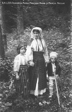 an old black and white photo of three women standing in the woods with two children