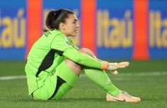 a female soccer player sitting on the ground