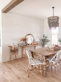 a dining room with white walls and wooden floors