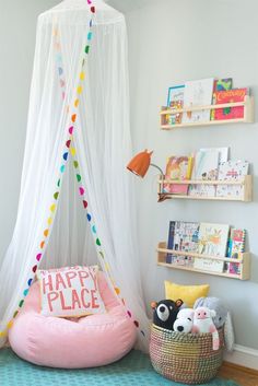 a child's room with a bed, bookshelf and toys on the floor