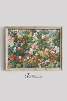 a painting hanging on the wall with flowers in it