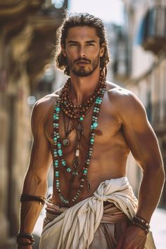 a shirtless man wearing beads and necklaces on his chest is standing in the street