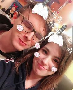 a man and woman with fake flowers on their foreheads posing for a photo together