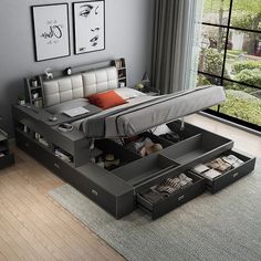 a bed with drawers underneath it in a room next to a window and a rug on the floor