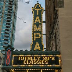 the marquee for tampa's broadway musical theatre is lit up in front of tall buildings