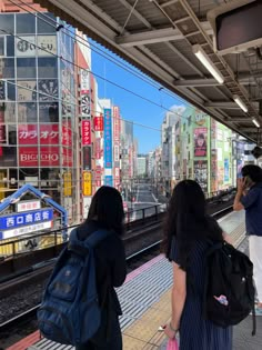 two women are waiting for the train to arrive