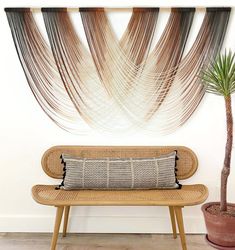 a wooden bench sitting next to a potted plant