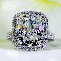 a cushion cut diamond surrounded by pave diamonds