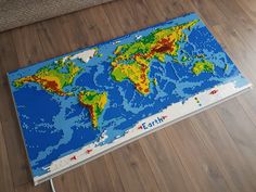 a large lego world map on the floor