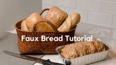 bread in a basket next to a loaf of bread on a counter with a knife