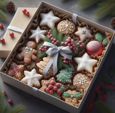 an open box filled with christmas cookies on top of a table