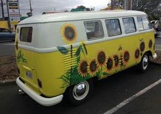 a yellow and white van with sunflowers painted on it