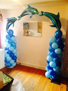 blue balloons in the shape of dolphins are on display