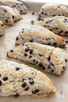 chocolate chip scones sitting on top of a baking sheet